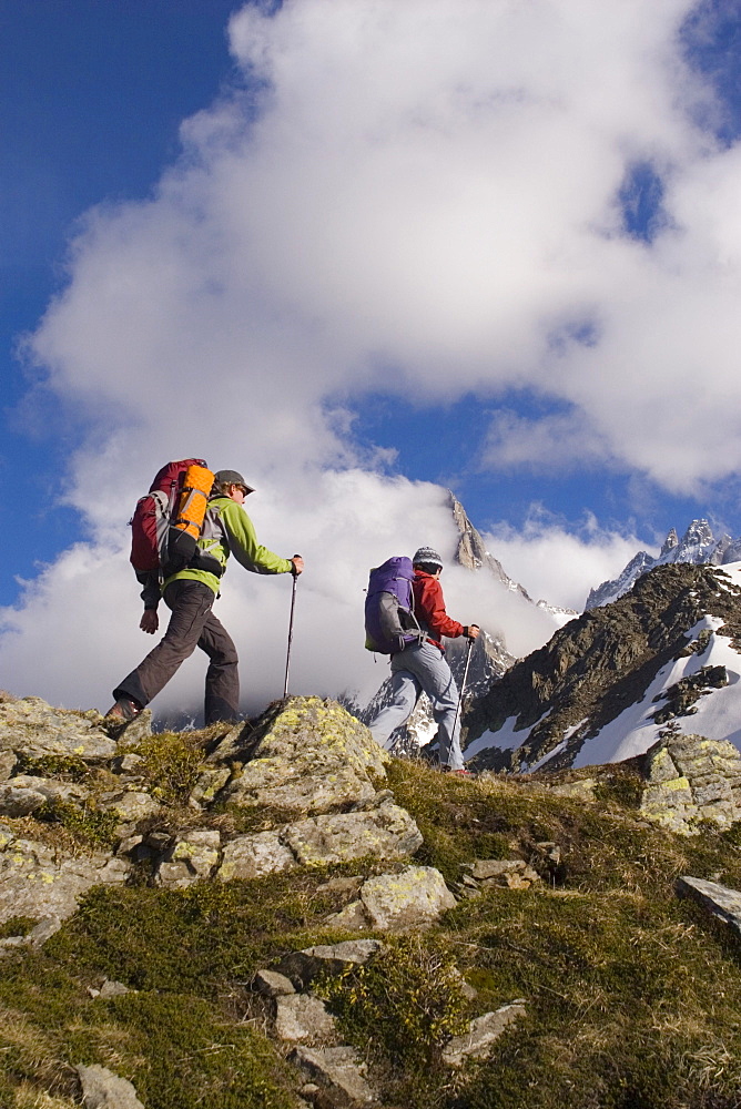 Two hikers climb a ridge near Mont Blance in France.