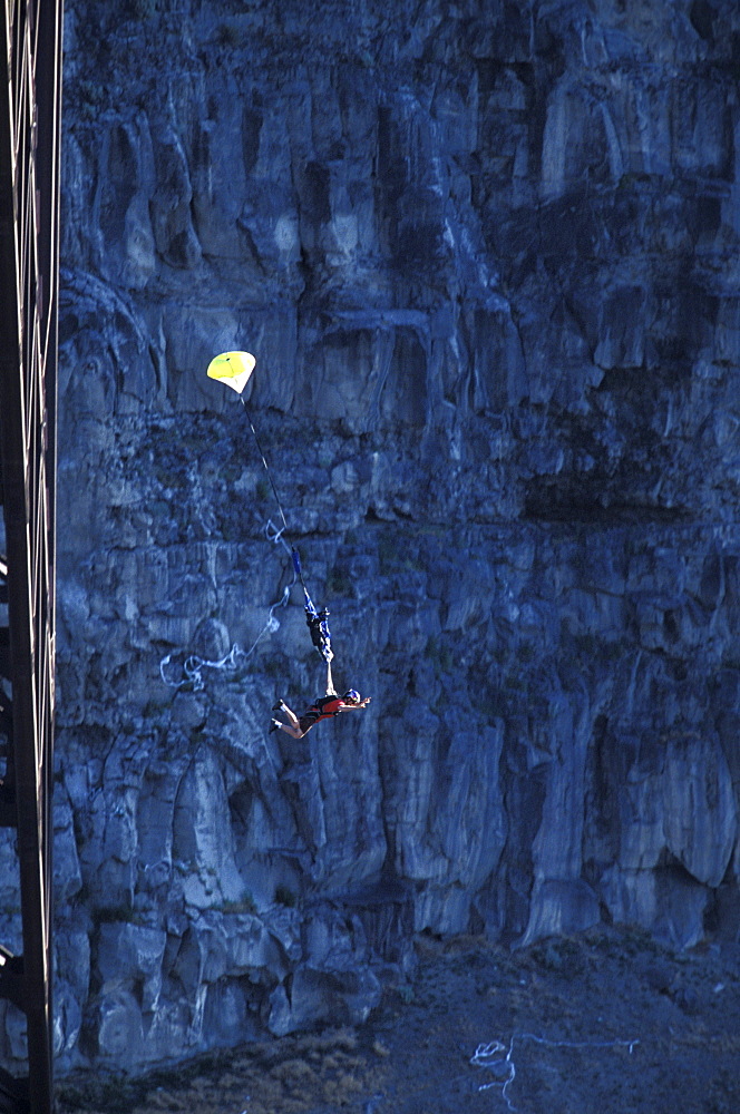 A BASE jumper opens his parachute after jumping off of a bridge in Twin Falls, Idaho.