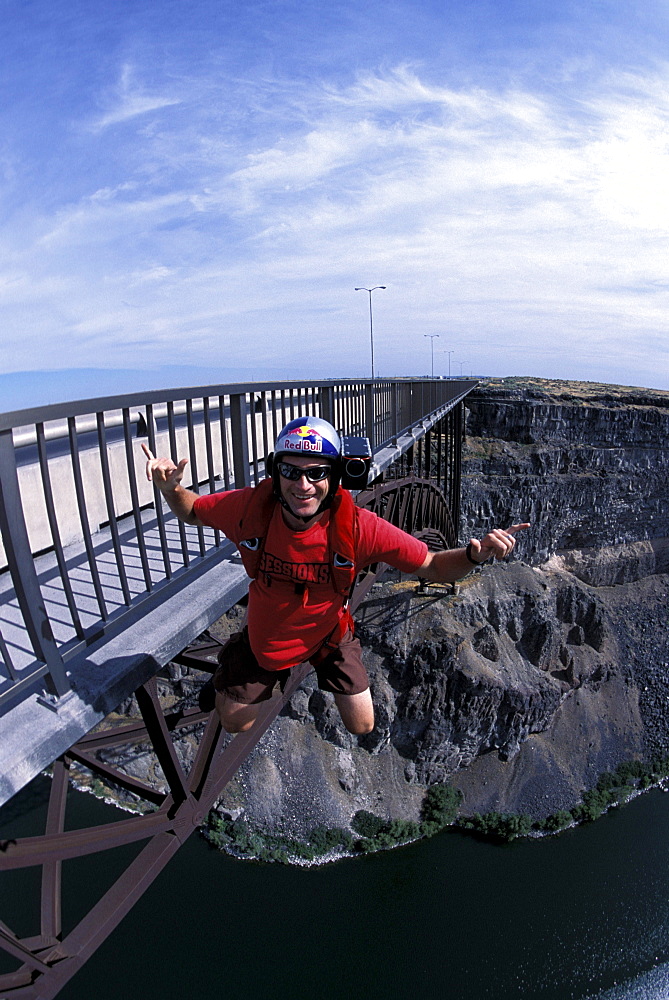 A BASE jumper smiling at the camera as he jumps off of a bridge in Twin Falls, Idaho.