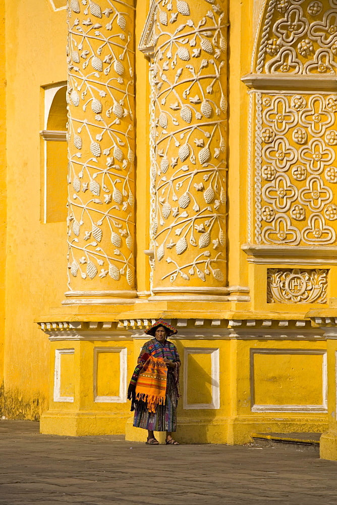 A woman in front of the church La Merced, Antigua, Guatemala