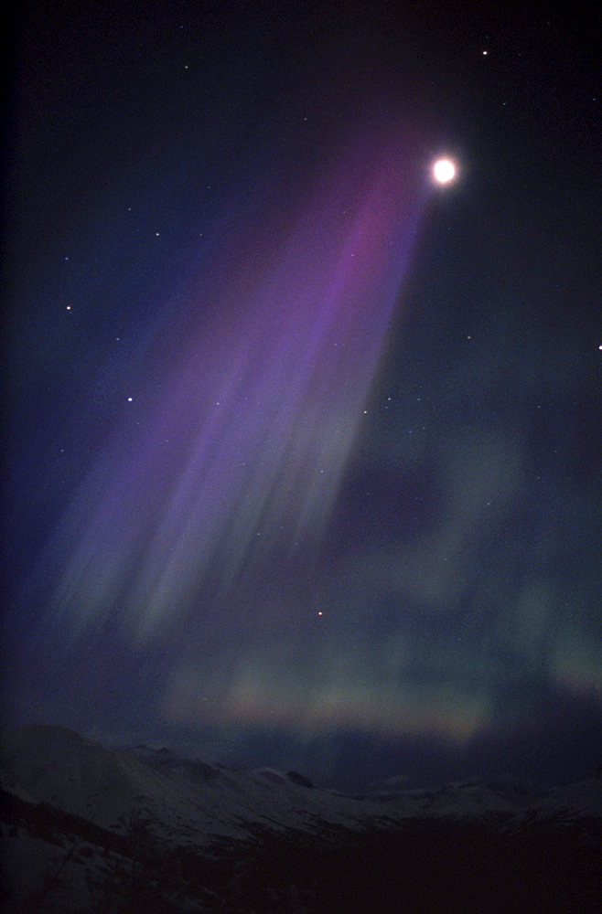 A purple-hued aurora borealis (northern lights) display paints the sky above Arctic Valley in Anchorage, Alaska.