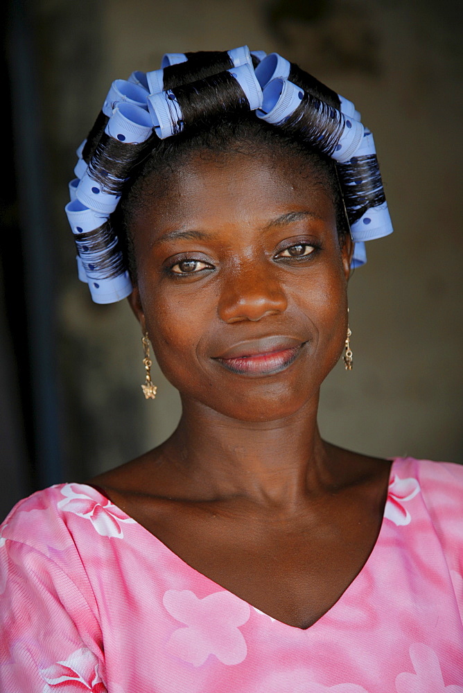 Young Ghanaian woman with curlers in her hair