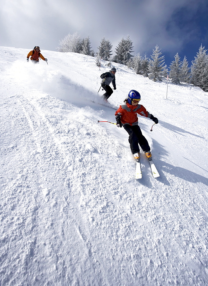Three people skiing in France.