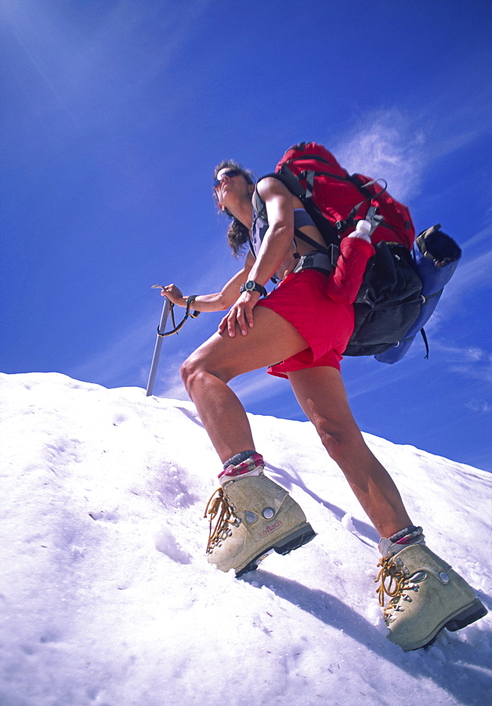 Kelley Jackson, scales a steep snow slope on Mt. Baker, Washington.