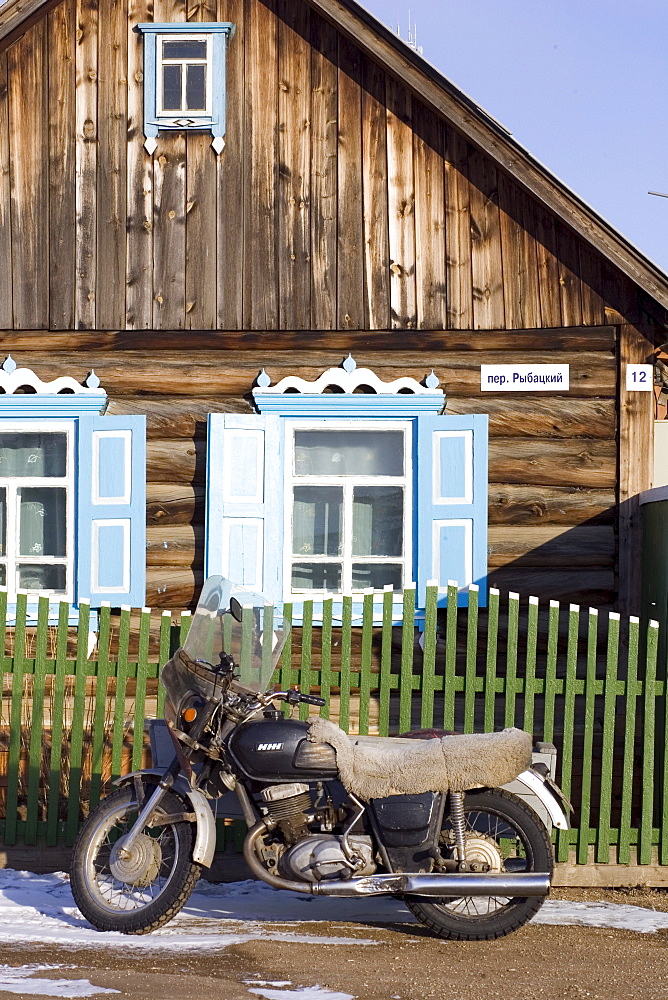 A motorbike parked outside of a home in a local village on Olkhon Island, Siberia, Russia.