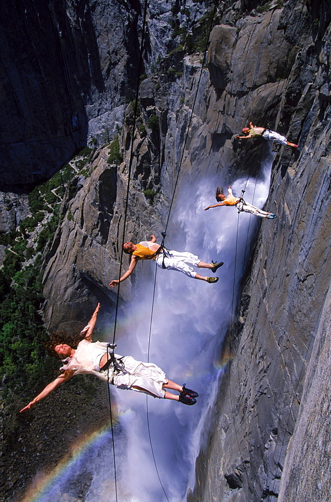 Suspended from wires 2,500 vertical feet up a cliffside in Yosemite National Park, the Bandaloop Troupe performs an air dance next to Yosemite Falls.