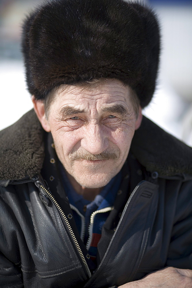 A portrait of a local man in the town center during the winter in Baikalsk, Siberia, Russia.