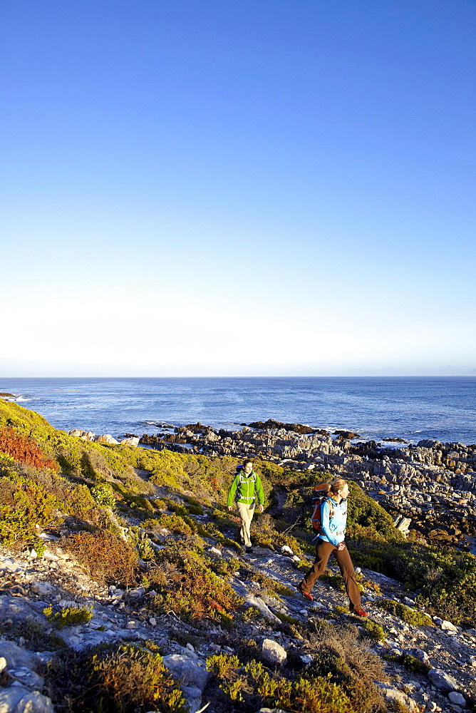 Katrin Schneider and Susann Scheller hiking on an ocean trail between Gansbaai and De Kelders. South Africa.