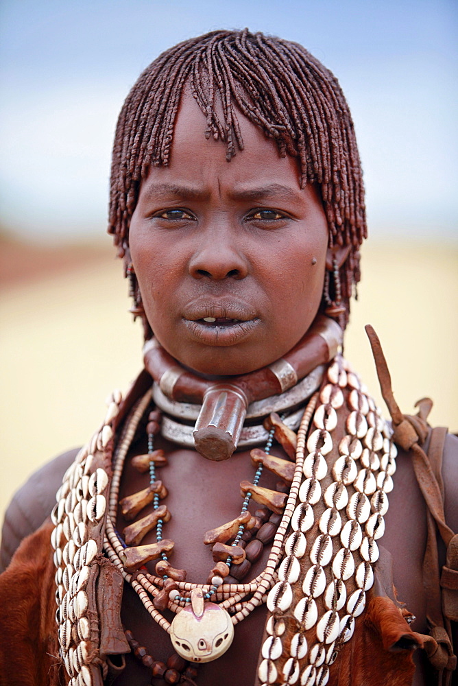 Hamar women are known for practice of body adornment and roll their locks with fat and red ochre (assile) and than twist them into crimson-colored dreads called Goscha, a style that men find attractive.  Dimeka, Omo Valley, Ethiopia, 2010