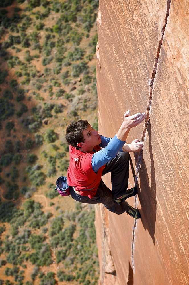 A man rock climbing in Zion National Park, UT.