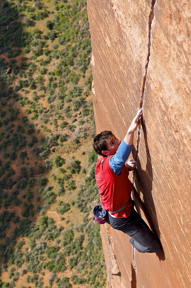 A man rock climbing in Zion National Park, UT.