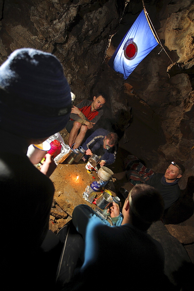 Explorers gather round at an underground camp in a cave in China.