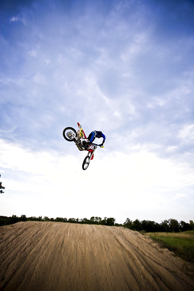 Rear-view of a motocross biker about to land a stunt in Brainerd, Minnesota.