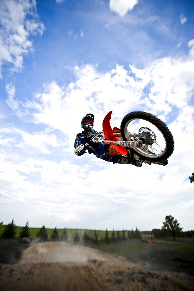 A motocross biker shows off a horizontal stunt during a jump in Brainerd, Minnesota.