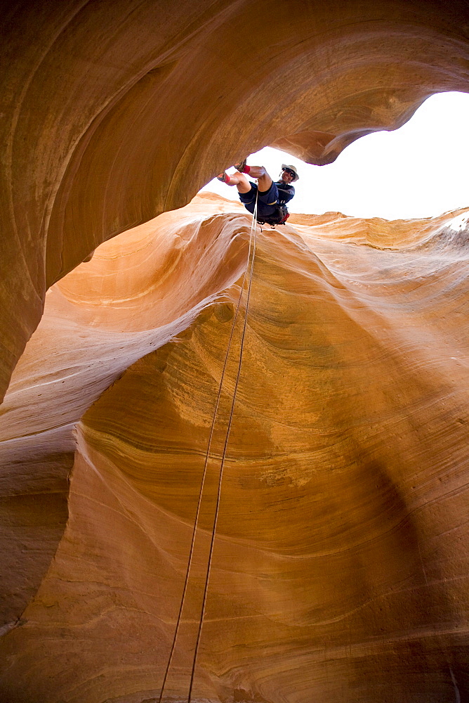 Mark Howe rappells into Fry Canyon, Utah.