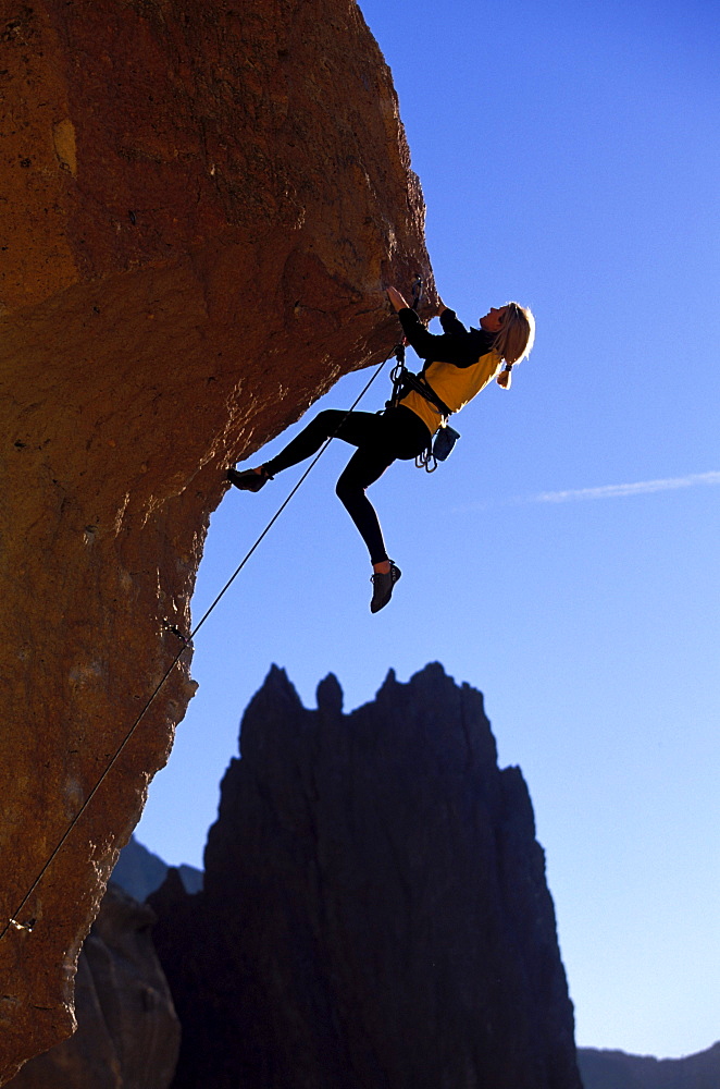 Nancy Prichard climbing Chain Reaction 5.12c at Smith Rock near Bend, Oregon.