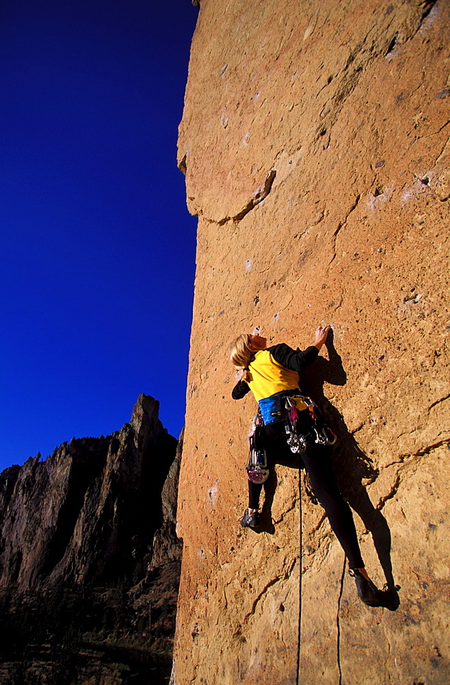 Nancy Prichard climbing Chain Reaction 5.12c at Smith Rock near Bend, Oregon.