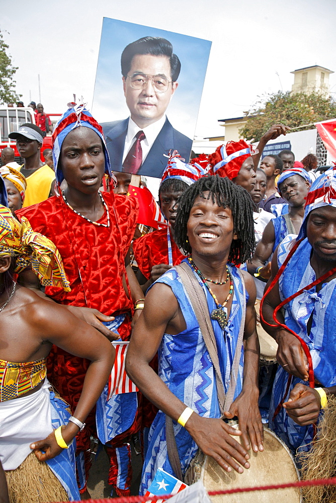 Liberians line the streets of Monrovia, Liberia to celebrate Chinese President Hu's visit. Besides rebuilding the National football stadium Chinese aid to the war torn nations is very popular with the locals. Liberia is rich in iron ore, timber, rubber and other resources which are desired by China.