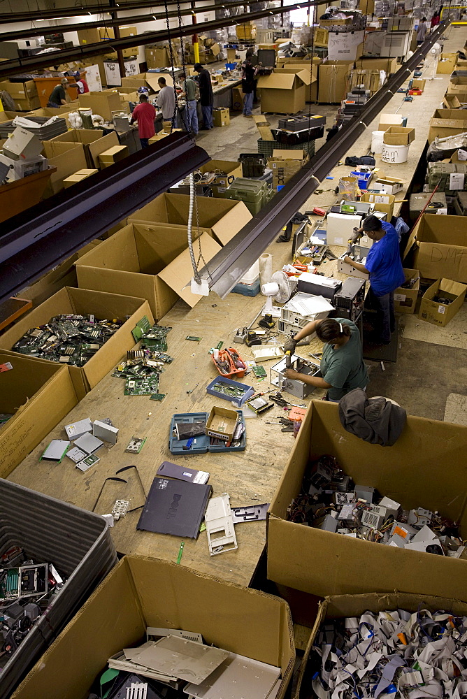 Electronics recycler Global Investment Recovery facility in Salley, South Carolina. The building was formally the Salley Manufacturing Plant, an apparel company that closed and moved operations to Honduras leaving about 100 people out of work. Global Investment Recovery refurbished the building and stated a state-of-the-art electronics recycling operation. They process all of the South Carolina government e-scrap for 21 cents a pound. Scott Dillon cleaning processors, most of which will be sold for reuse. On the right side is hard drives that are wiped 7 times and will be resold. Terry Davis shrink wraps monitors, most of which will be sent overseas for reuse.