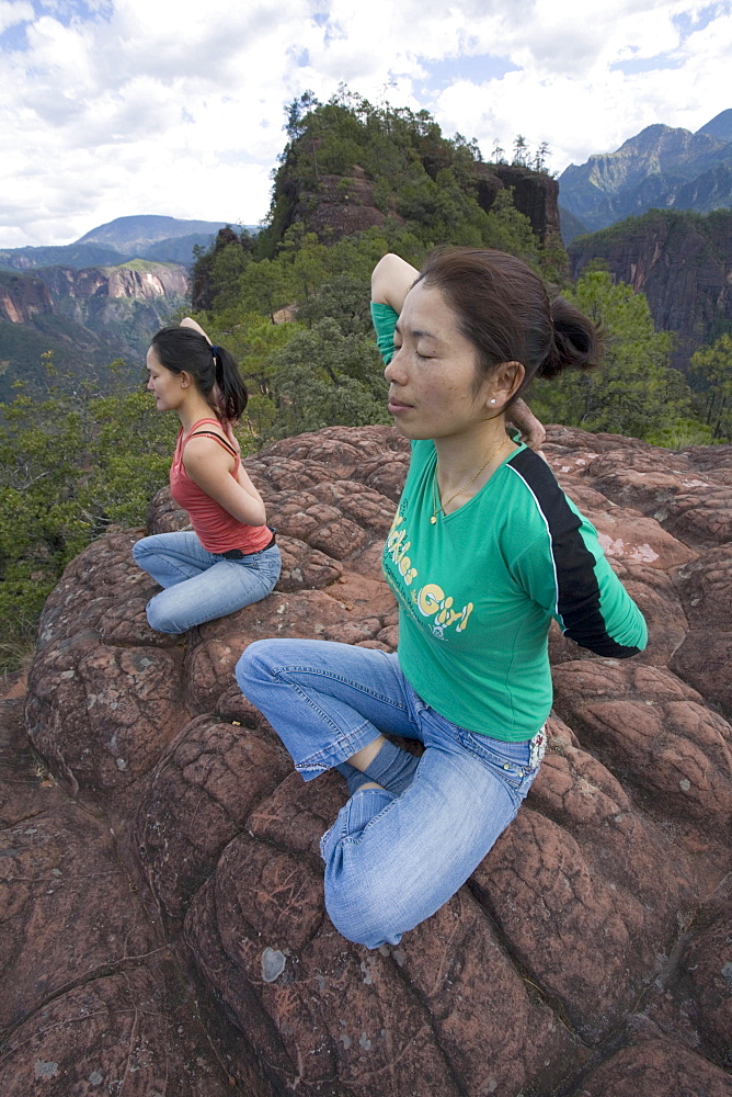 Hikers practice yoga on top of Thousand Turtle Mountain in the Laojun Mountain Nature Reserve north of Lijiang, Yunnan Province, China.