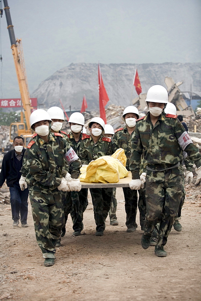 A team of Chinese soldiers carry the body of an earthquake victim in Yinghua, China.