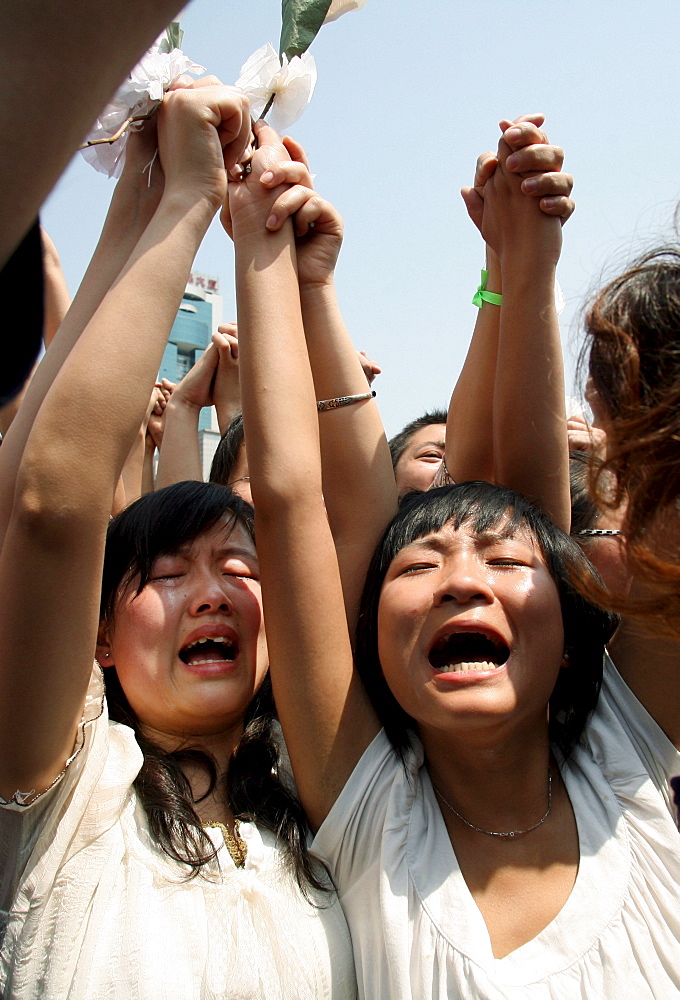 Chinese mourners shout nationalist slogans after a three minute silence to grieve Sichuan's earthquake victims in Chengdu's central square.