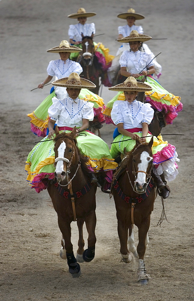 Members of the El Herradero team compete in an Escaramuza in Mexico City, Sunday, February 10, 2008.  Escaramuzas are similar to US rodeos, where female competitors called "Amazonas" wear long skirts, and ride side saddle.  Male rodeo competitors are "Charros," from which comes the word "Charreria." Charreria is Mexico's national sport.