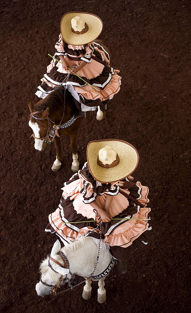 Escaramuza from Anahuac of Tecamac team ride their horses in a rodeo competition in Chalco on the outskirts of Mexico City, May 10, 2008. Escaramuzas are similar to US rodeos, where female competitors called "Amazonas" wear long skirts, and ride side saddle. Male rodeo competitors are "Charros," from which comes the word "Charreria." Charreria is Mexico's national sport.