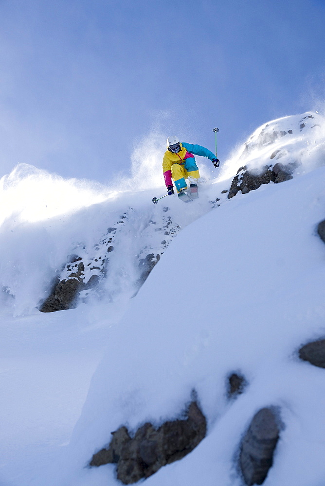 A man skiing powder snow at Kirkwood ski resort in the Sierra mountains of California