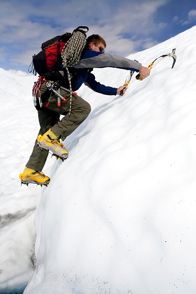 Ice climber traverses across Matanuska Glacier in Alaska.