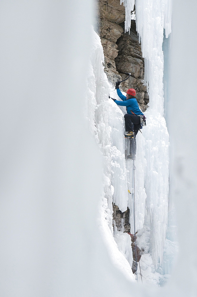 Man climbing ice in the Ouray Ice Park, Ouray, Colorado.