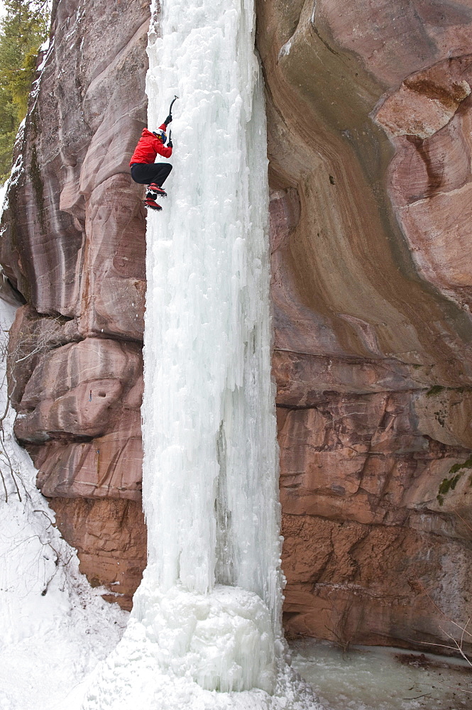 Man climbing ice pillar without a rope, Redstone, Colorado.