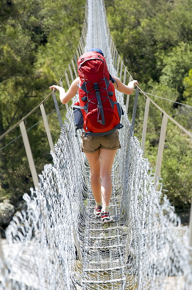 Hiker crossing the Bowtell Swing Bridge.