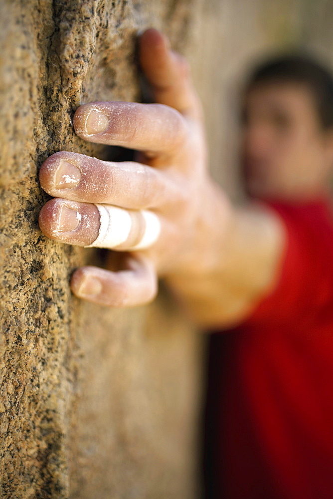 Male climber's hand on rock.