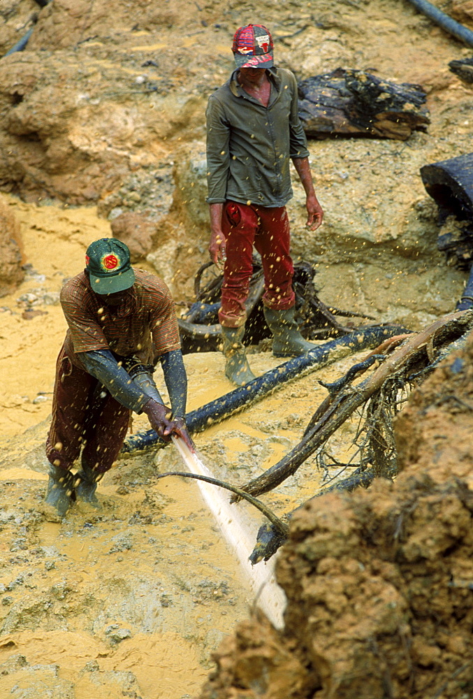 Gold mining in a forest near Benzdorp. Miners, mostly Brazilians, use high pressure hoses for mining. Suriname