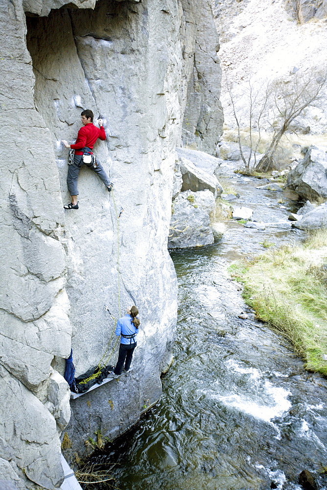 Two climbers above river