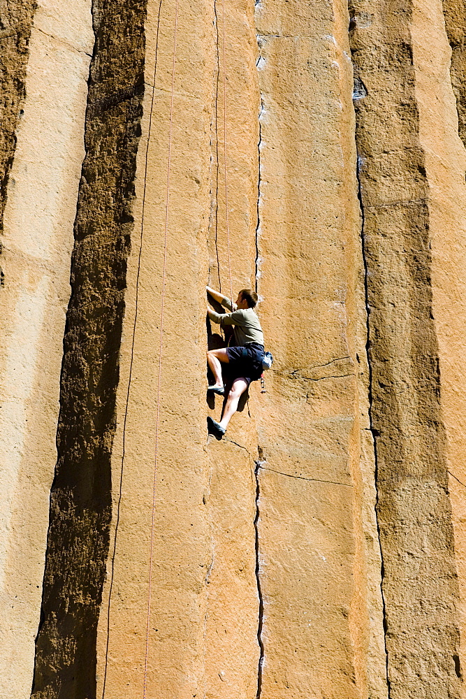 A mid adult man rock climbing at Trout Creek, Oregon.