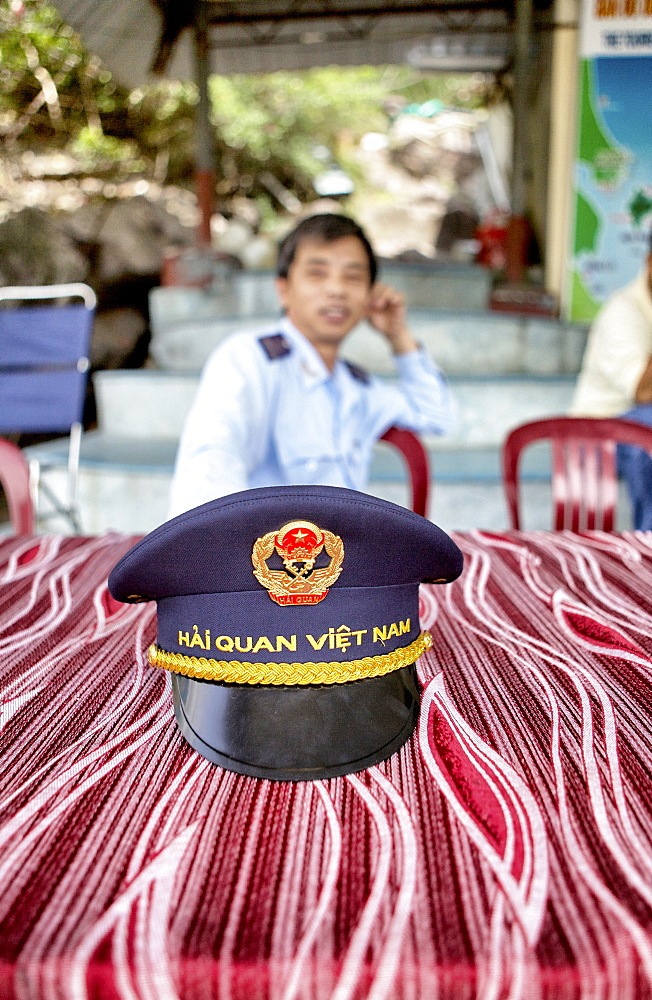 Vietnamese custom officer waiting for new arrival in the Nha Trang harbor, Vietnam.