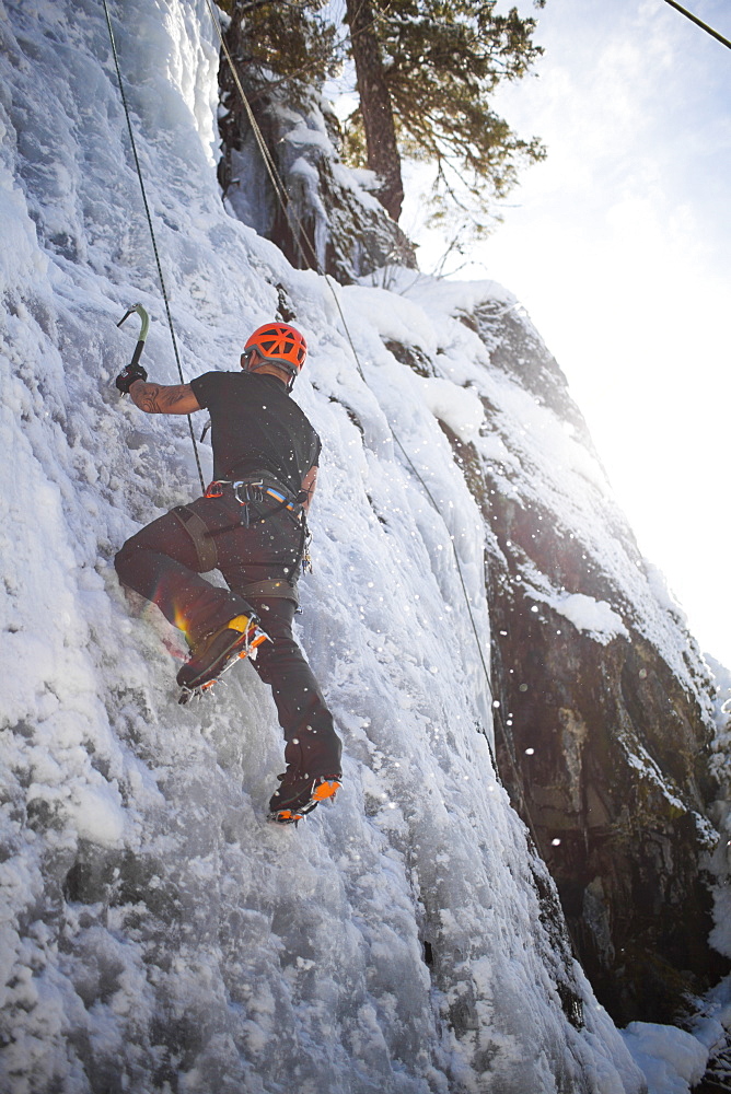 A man climbs a frozen waterfall in Whistler, British Columbia, Canada, Whistler, British Columbia, Canada