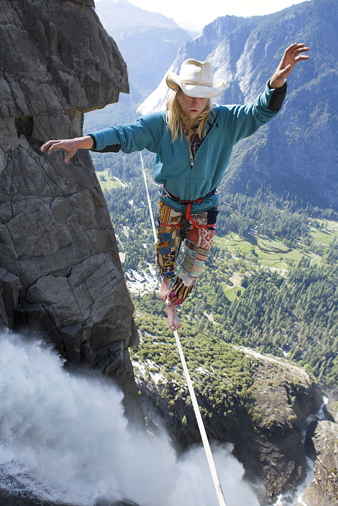 Male highliner walking the Yosemite Falls highline, Yosemite Valley, California, United States