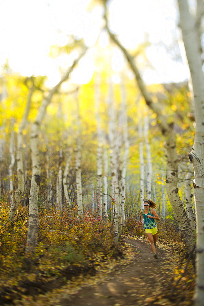 Woman running on a trail in Park City, Utah.