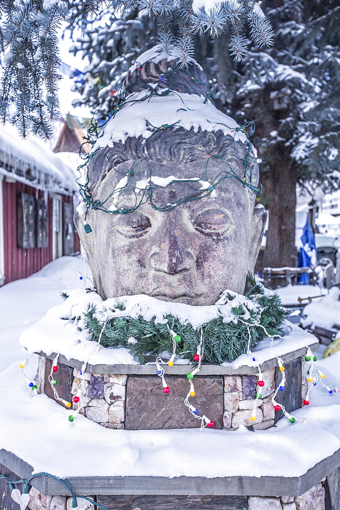 A snow covered Buddah statue in the town of Crested Butte, Colorado, during the holidays.