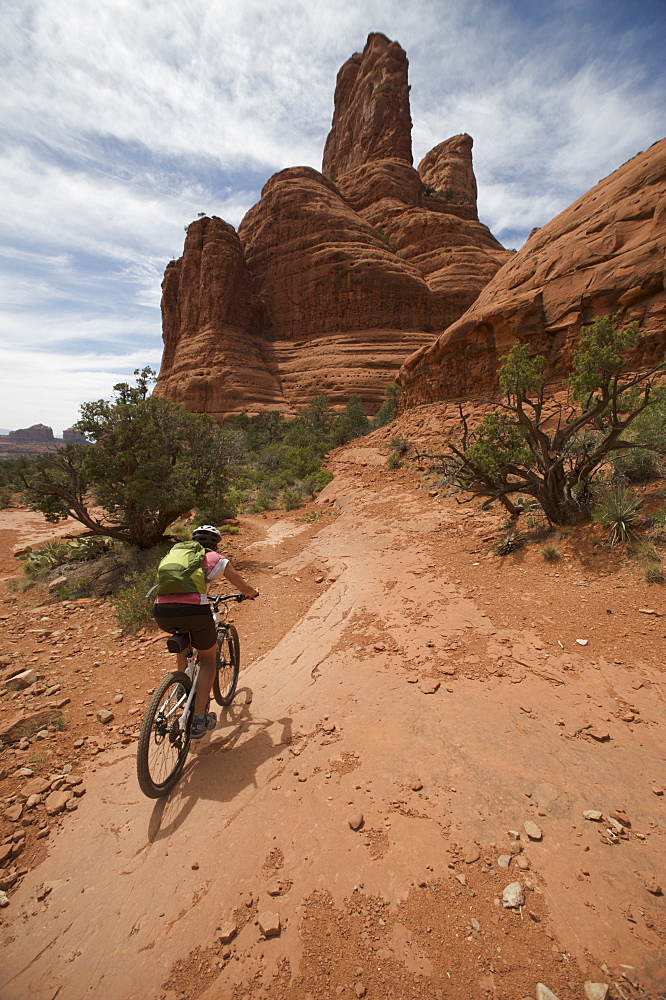 Woman rides the Submarine Rock Loop in South Sedona, Arizona. The trail has everything from slickrock to single track to stairs that lead to Submarine Rock.