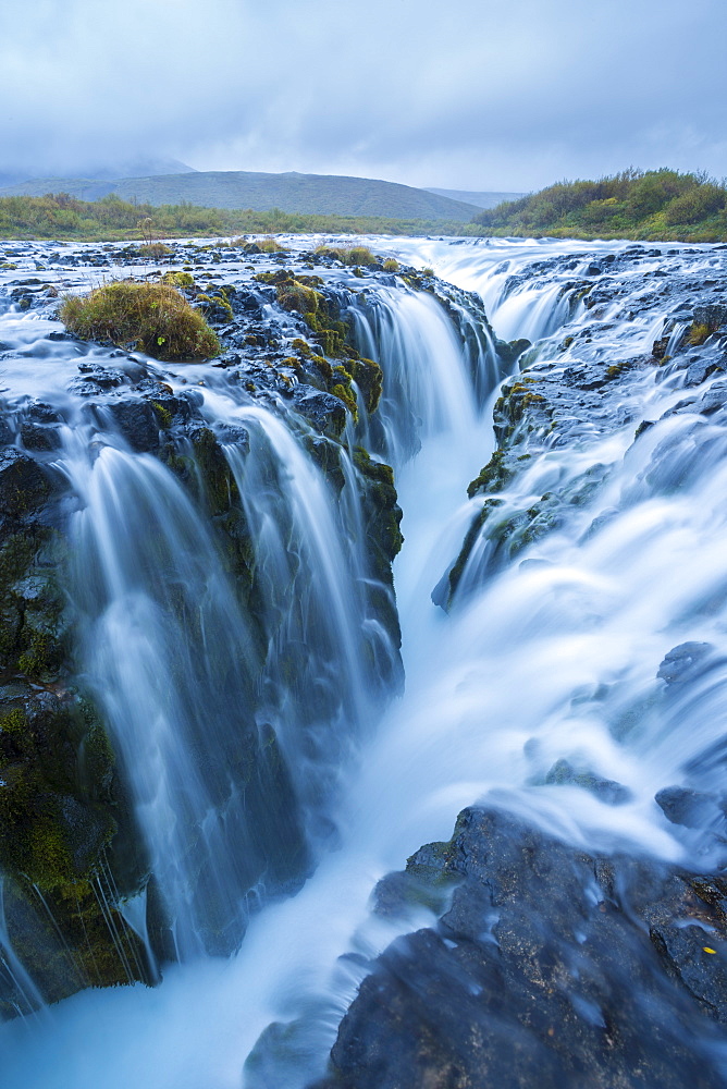 A unique waterfall that falls into an old vocanic fault known as Brúarfoss in Iceland.