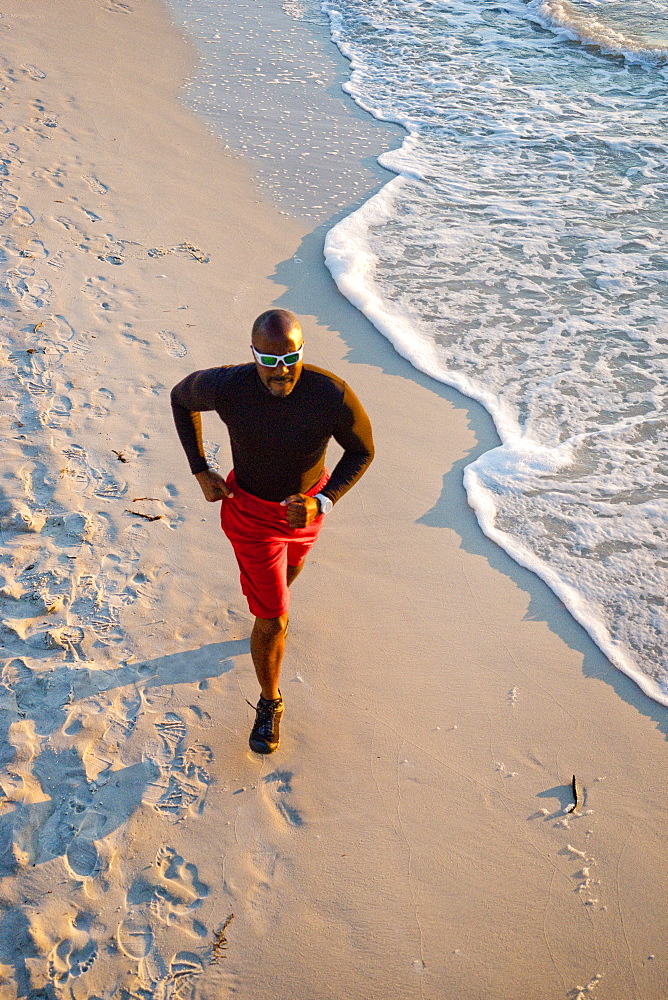 Man running on the beach, from above