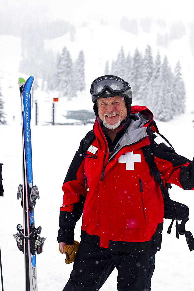 Court Wing, a legendary ski patroller at Steven's Pass, WA with his dog on a snowy day, United States of America