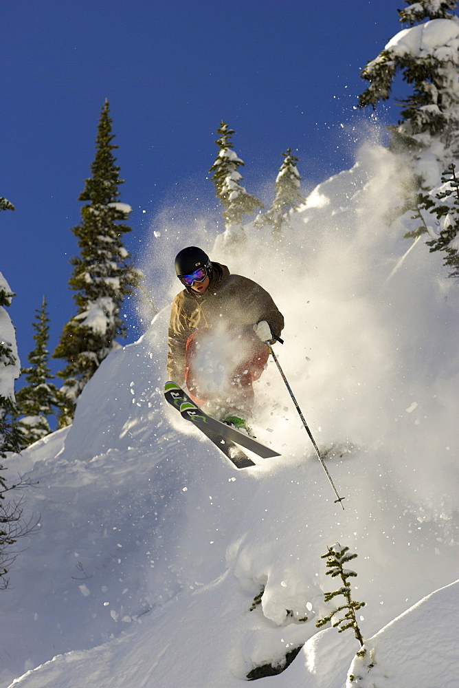 Ian McIntosh getting some air on ski's at Whistler resort with evening light, British Colombia, Canada. December 2006, Canada