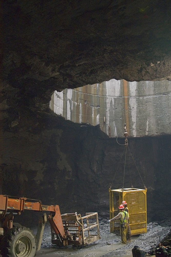 TUNNEL WORKERS UNDERGROUND WITH HEAVY EQUIPMENT, United States of America