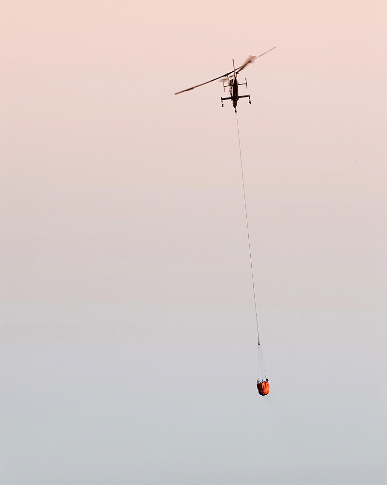 Helicopters pick up water from a reservoir while fighting wildfires in Santa Barbara, California, United States of America