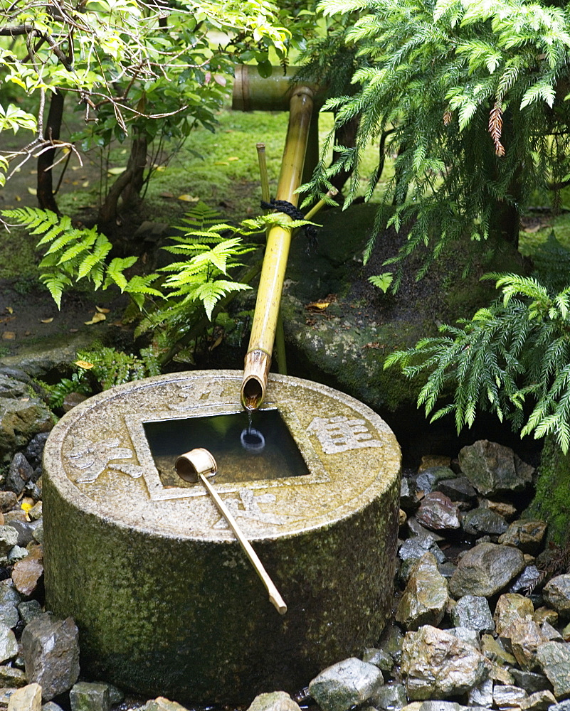 Ryoan-ji's tsukuba, a small basin provided at Japanese Buddhist temples for visitors to purify themselves by the ritual washing of hands and rinsing of the mouth. Kyoto, Japan, Japan